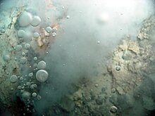 Carbon dioxide bubbles are emitted from white smokers at the Champagne vent site in Eifuku. Eifuku chimneys bubbles.jpg