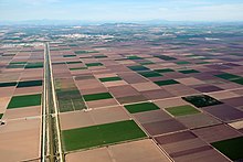 Irrigation of agricultural fields in Andalusia, Spain. Irrigation canal on the left. Fields SW from Sevilla.jpg