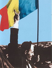 Deputy Gheorghe Ghimpu replaces the Soviet flag on the Parliament with the Romanian flag on 27 April 1990. Gheorghe Ghimpu arboreaza Tricolorul.jpg