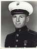 A black and white image showing Perkins head and upper torso in his military dress uniform with hat.