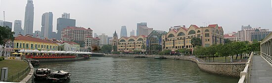 Panoramic view of the Singapore River. There are numerous bars, pubs, seafood restaurants and tall commercial buildings along the river.