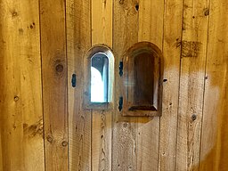 The leper window near the altar in the Hopperstad Stave Church Replica allowed the individuals with Leprosy to see the service and receive communion while remaining outside of the church.