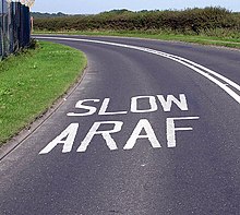 Bilingual road markings near Cardiff Airport, Vale of Glamorgan Wales.cardiff.slow.jpg