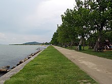 Lake Balaton on the left with a view of the green grass beach on the right