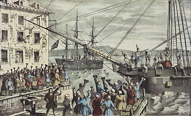 Two ships in a harbor, one in the distance. On board, men stripped to the waist and wearing feathers in their hair throw crates of tea overboard. A large crowd, mostly men, stands on the dock, waving hats and cheering. A few people wave their hats from windows in a nearby building.