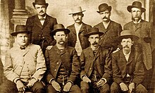 Bat Masterson (standing second from right), Wyatt Earp (sitting second from left), and other Deputy Marshals during the Wild West era. Some of the earliest types of law enforcement in the U.S. DodgeCityPeaceCommission.jpg