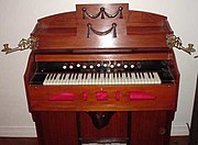 A harmonium. Operation of the two large pedals at the bottom of the case supplies wind to the reeds.