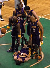 Los Angeles Lakers' Kobe Bryant, wearing a Philadelphia Eagles Donavan  McNabb football jersey, cheers on his team during fourth quarter action  against the San Antonio Spurs, February 3, 2005, at Staples Center