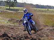 A rider using a berm to corner during a motocross race in Australia