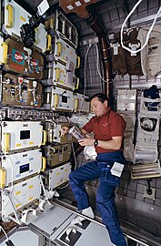 Russian cosmonaut Vladimir Titov works with samples for the CGBA