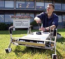 An agricultural and biosystems engineer fixing an agricultural robot US Navy 060427-N-1825C-001 Combat Systems Sciences and Technology Program Naval Postgraduate student Ensign Tom Dunbar, works with an autonomous robot originally designed to maneuver in agricultural settings.jpg