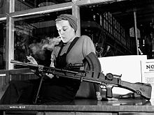 Veronica Foster, popularly known as "Ronnie, the Bren Gun Girl" on the production line. Many women worked "on the home front" during the war. VeronicaFoster-RonnieBrenGunGirl-smoke.jpg