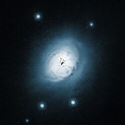 Image of the outer dust around the young star HD 100546. The position of HD 100546 b was indicated by an orange dot. View of the dust disc around the young star HD 100546.jpg