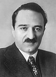 The photo depicts Anastas Mikoyan as seen on his state visit to the German Democratic Republic in April 1954