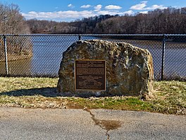 A photograph of an onsite dedication stone to wilderness activist Bernard Frank, after whom the lake is named in honor.