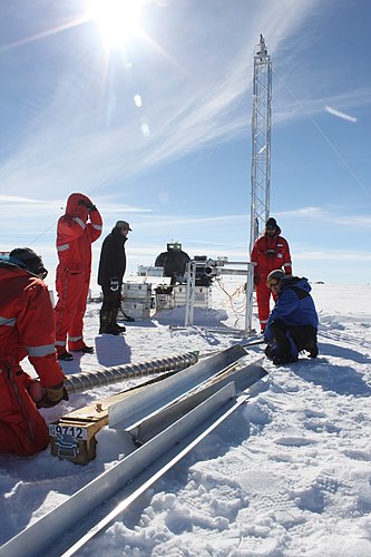 Ice Core Researchers in Greenland by Helle Astrid Kjær. Ice core researchers drilling at the East Greenland Ice-Core Project site.