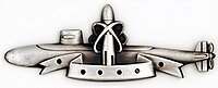 Silver SSBN Deterrent Patrol insignia, depicting a nuclear submarine with a superimposed ballistic missile, framed by lines reminiscent of an atomic nucleus, indicating the missiles contain nuclear warheads.