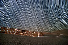 Star trails caused by the Earth's rotation during the camera's long exposure time Star trails over the Paranal Residencia, Chile.jpg