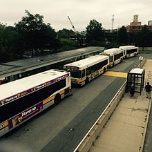 Buses forming a "bus bridge" linking JFK/UMass and North Quincy in August 2015, during winter resiliency work Bus Bridge at JFK-UMass Station, August 2015.jpg