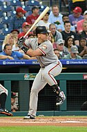 Baseball player cocking leg to stride into swing