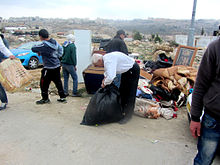 The Idris family collecting their belongings after the demolition (Beit Hanina, 2014) Five demolitions in East Jerusalem, January 2014 (6 3).jpg