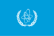 The International Atomic Energy Agency was created in 1957 to encourage peaceful development of nuclear technology while providing international safeguards against nuclear proliferation. Flag of IAEA.svg