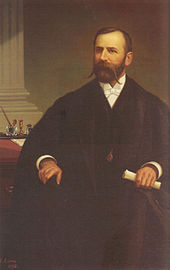 Wilson, appearing about age 40, in formal dress (including white tie) and robes of office. He holds a rolled up piece of paper in his left hand. A watch or locket is visible on a chain, dangling (most likely) from his neck.