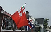Flag of New England flying in Massachusetts. New Englanders maintain a strong sense of regional and cultural identity. NE Flag red.jpg