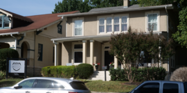 A large 1920s style house in Nashville with a sign out front that reads, "Interstate Music."