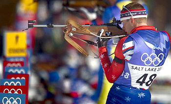 Sportovní fotografie biatlonisty Jeremyho Teely při střelbě vstoje ve vytrvalostním závodě Zimní olympiády 2002