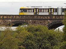 A Metrolink tram in Radcliffe, part of Greater Manchester's light rail network Metrolink Tram, Radcliffe Viaduct.jpg