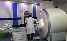 Patient being positioned for MR study of the head and abdomen Siemens Magnetom Aera MRI scanner.jpg