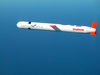 A cruise missile labelled with the Raytheon logo soars through the air