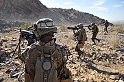 A fire team from the 2nd Marine Regiment advances toward their downed targets, wrapping up a live-fire ambush and reaction drill at Camp Billy Machen Desert Warfare Training Facility (2009).