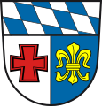 Landkreis Schwabmünchen (–1972) Unter Schildhaupt mit den bayerischen Rauten gespalten von Silber und Blau; vorne ein rotes Tatzenkreuz, hinten eine goldene heraldische Lilie.