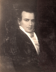 Dark-haired man with white tie and black coat