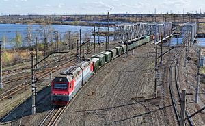 Electric locomotive 2ES6-137 with freight train leaves Golden Sopka station