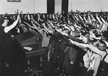 The Nazi salute in school (1934): children were indoctrinated at an early age. Bundesarchiv Bild 183-2007-0329-501, Reichsgrundungsfeier, Schulklasse.jpg