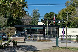 The entrance to the Colegio del Verbo Divino, with a parking lot and a low modern building