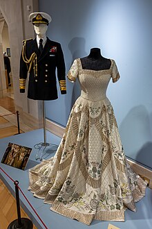 Replica coronation gown of Elizabeth II and wedding suit of Prince Philip used in the series Costumes from The Crown.jpg