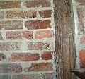 Detail of construction technique, Cousin House. Photo shows original construction, c. 1787–1789. The bricks were made on site. The cypress beams are also believed to have come from the site. The mortar is clay. The plaster, shown over parts of the mortar, consists of human and horse hair, Spanish moss, and other materials.