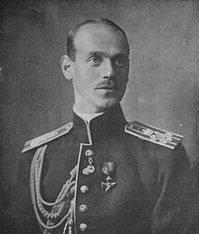 White male with classically-handsome features and a thin moustache wearing military uniform
