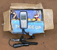 Information and communication technologies for development help to fight poverty. A mobile phone being charged from a car battery in Uganda. Kiwanja uganda charging 1.jpg