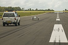 Sunswift IV and control vehicle during speed record attempts at HMAS Albatross Solar car LSR.jpg