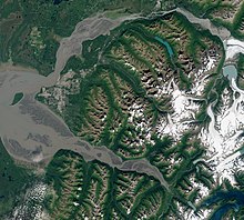 Satellite view taken August 2020. The Municipality encompasses the entire land mass between the Knik River and Knik Arm (top), and the Turnagain Arm (bottom), with the Mat-Su borough to the north, the Kenai Peninsula to the south, and Whittier just east of the mountains (lower right). The city proper lies on the coastal alluvial plain at the headwaters of Cook Inlet, between the two arms (left of center). Anchorage by Sentinel-2, 2020-08-17.jpg