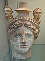 Female head partially imitating a vase (lekythos) - 325 - 300 BC.