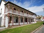 DOUBLE STOREY, SINGLE PILE 6 BAY ASYMMETRICAL PLAN PLUS ADDITIONS. DOUBLE STOREY WOODEN VERANDAH. SLATE ROOF AND WALLS BRICK PLASTERED. LARGE PANE SASH WINDOWS AND FRENCH DOORS UPSTAIRS. ON STREET. VERY IMPORTANT BUILDING. ON 1863 MAP. ORIGINALLY C1840. MODERNISED C1880. SEE P.70 IN GRAHAMSTOWN FROM COTTAGE TO VILLA BY R & B REYNOLDS. Type of site: House Current use: Domestic – House.