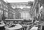 A RAF Bomber Command crew examines a barrel in a Krupp workshop in Essen Germany after World War II.