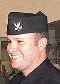 A U.S. Navy Petty Officer Second Class wearing the former winter blue uniform garrison cap GarrisonCap.jpg