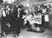Louise Weiss along with other Parisian suffragettes in 1935. The newspaper headline reads "The Frenchwoman Must Vote". Louise Weiss.jpg
